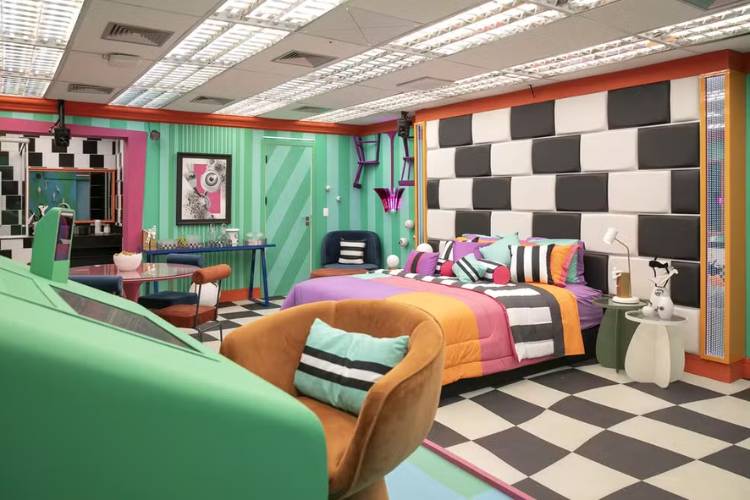 Quarto do líder em tons de verde, preto e branco, com colcha laranja e muitos detalhes em formas geométricas. 