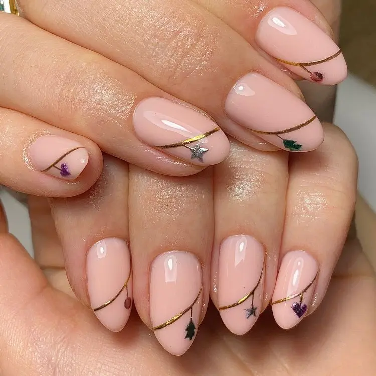 unhas amendoadas decoradas com enfeites de Natal em prata e dourado