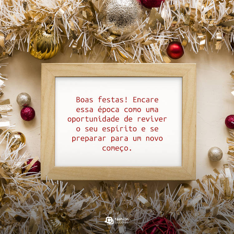 Mesa bege com enfeites natalinos e quadro com frase: Boas festas! Encare essa época como uma oportunidade de reviver o seu espírito e se preparar para um novo começo.
