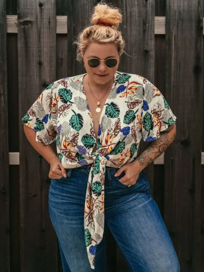 Mulher com blusa estampada amarrada na frente e calça Jeans - Sou Plus Size