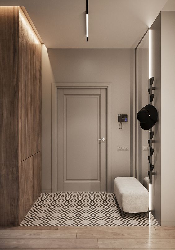 Hall de entrada com parede de madeira e cinza, gancho vertical preto para chapéu e banco de estofado off white