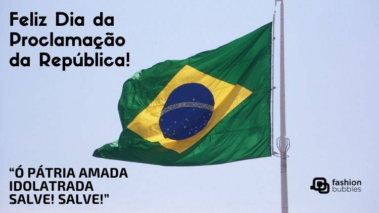Foto de bandeira do Brasil hasteada, com frases "Feliz Dia da Proclamação da República" e  “Ó Pátria amada / Idolatrada / Salve! Salve!” (Hino Nacional Brasileiro)