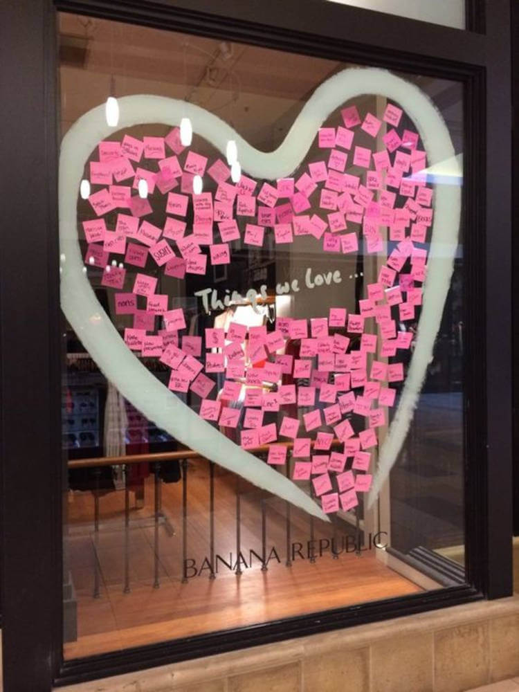Recados colados no vidro. Vitrine com post its cor de rosa.