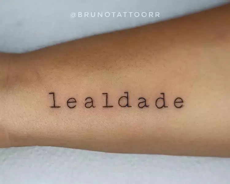 tatuagem escrita lealdade no braço