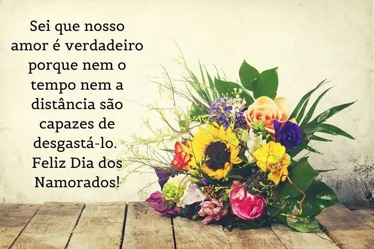 Foto de buquê de flores diferentes e frase "Sei que nosso amor é verdadeiro porque nem o tempo nem a distância são capazes de desgastá-lo. Feliz Dia dos Namorados!"