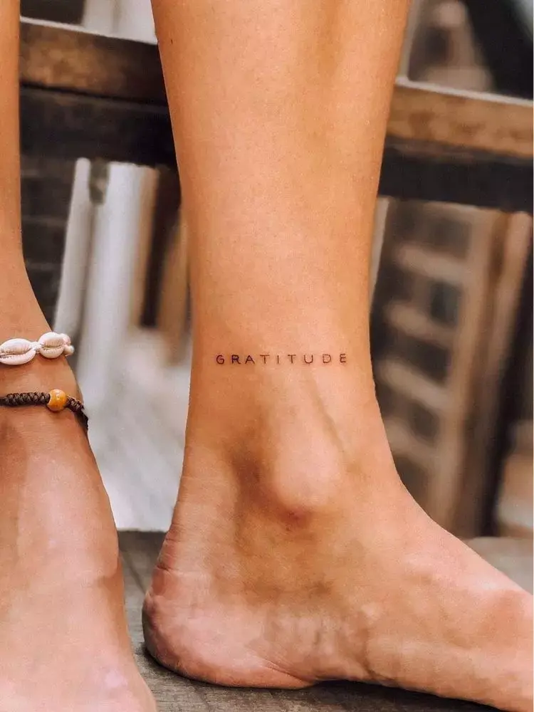foto de homem com palavra tatuada no pé