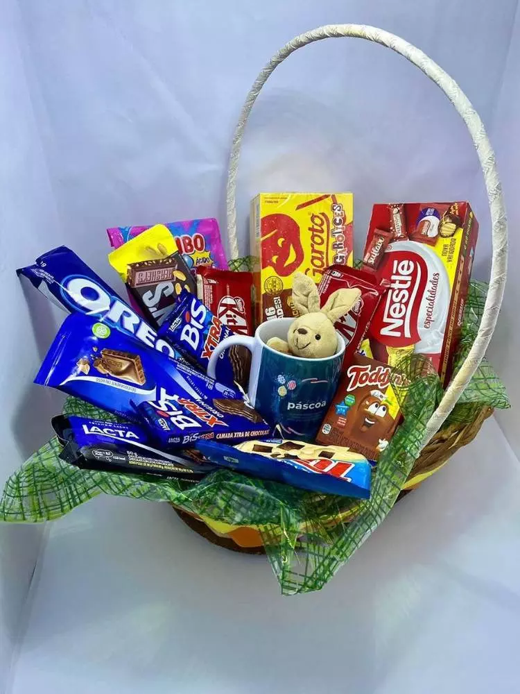 Cesta de Páscoa com doces, caneca azul e coelho de pelúcia